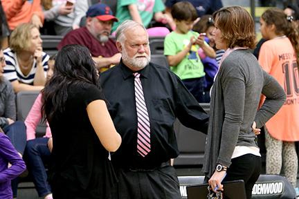 Former Lindenwood women's volleyball coach Ron Young talks to his assistant coaches prior to a match. Photo by Don Adams Jr.