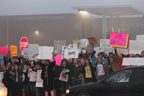 Students at Fort Zumwalt East High School thrust signs into the air in protest of the expected visit from Westboro Baptist Church to their school.