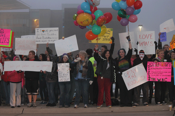 Several students and adults rally in front of the main entrance to Fort Zumwalt East High School on Monday, Feb. 6, during the early morning hours as students were to arrive at school.