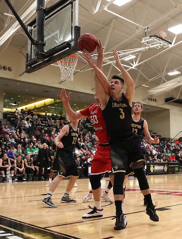 University of Central Missouris Jakob Lowrance (50) and Lindenwoods guard Jake Showalter (3) battle for the ball during the second half of the blackout game on Wednesday.
