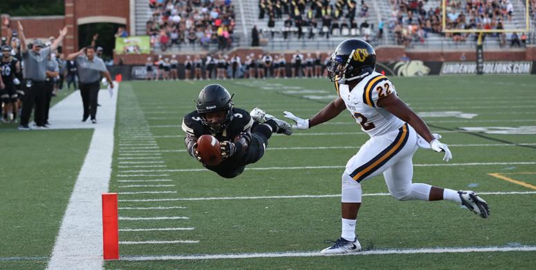 Lindenwood receiver Kendell Sparks dives horizontally into the endzone past Central Oklahoma defensive back Braden Calip for the teams first touchdown of the 2016 season. Sparks tallied 106 yards and two touchdowns in the home-opener on Sept. 1. 
 Photo by Carly Fristoe
