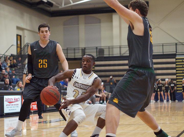 Bakari Triggs attempts to split the Missouri Southern defenders and drive toward the hoop.Photo by Phil Brahm