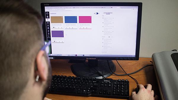 A student checks his Canvas dashboard for new assignments in his classes.  Photo Illustration by Kelby Lorenz