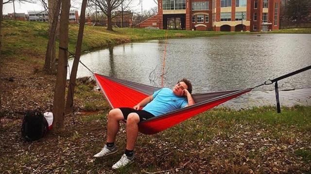 R.J. Dietrich, APO member, hammocks in front of the Student Athletic Center. <br> Photo from Hanna Wyland. 