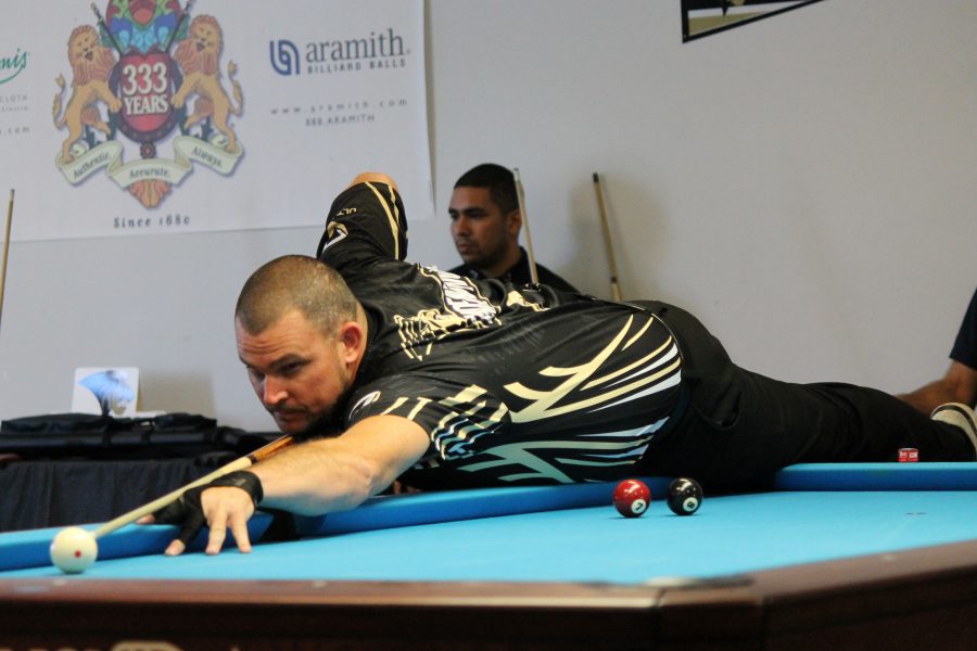 Brandon Jordan stretches across the table during the first set of his two win tournament.  <br>Photo by Walker Van Wey </br>