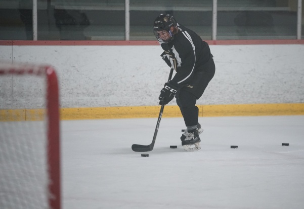 This file photo shows Freshman Dom Kolbeins skating up the ice towards the net with the puck during practice on Friday, September 30th.  Photo by Mitch Kraus
