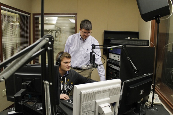 Student Dillon Archer (left) and Chad Briesacher on air in the KCLC radio station in the Spellmann Center on Sept. 27. In his new position, Briesacher will devote his full attention to KCLC. <br> Photo by Lindsey Fiala