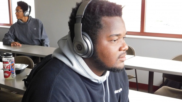 Junior, Franklin Green wears his signature gray Beat headphones after class.  Photo by Kat Owens 