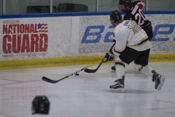 Junior forward Cade Owad attempts to take the puck from an opponent in an October 2016 game against Minot State. <br> File photo from Kelby Lorenz