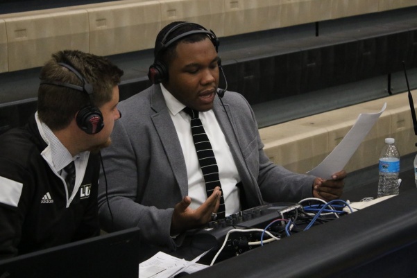 Adam Ziske (left) looks to broadcast partner Romero Starks as he breaks down the first half of the Lions basketball match up against Central Christian College of the Bible on Dec. 1..
Photo by Walker Van Wey