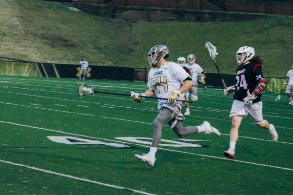 Lindenwood lacrosse player Max Hood runs down the field in the Lions 10-7 win over Wheeling Jesuit on Feb. 27 in Hyland Arena. 
 Photo by Andria Graeler.