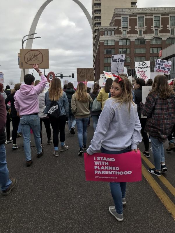 Julia Thorne, a psychology student from Lindenwood University, walked in the Annual Womens March in downtown St. Louis. She is holding a sign promoting Planned Parenthood, the program she is working with as a part of her practicum. 
Photo by Jessie Basler