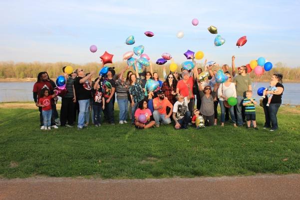 Friends and family gather in Frontier Park Thursday night to release balloons in memory of Tiffany Sabourin.  Photo by Lindsey Fiala