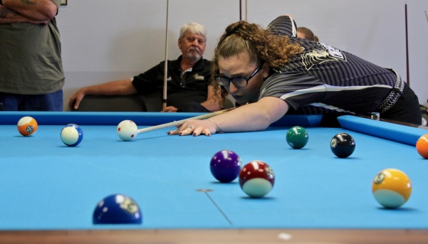 Freshman April Larson is preparing to execute a shot during singles matches on Saturday at the Lindenwood Billiards Arena. Larson has been national champion multiple times.  Photo by Mina San Nicolás Leyva