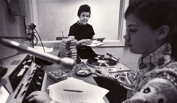 Martha Boyer, the woman largely credited with founding KCLC, helps a student doing an airshift during one of her last years at the university in 1970. Photo from the Mary E. Ambler Archives