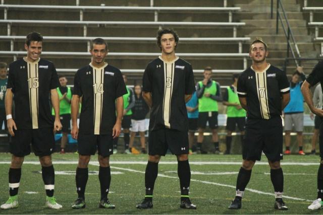 File photo: Leon Silva (far left) and Fernando Cordero (8) line-up with their Lindenwood teammates ahead of a Lions mens soccer game.   Photo courtesy of Leon Silva.  
