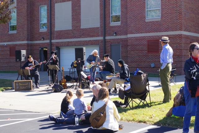 People gather to watch the Lindenwood staff and faculty band, Borrowed Notes, play at a homecoming event on Saturday. 