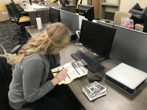 Haley Cluck stationed in the Student Involvement office, going over final details for Thursdays Headphone Disco party.  Photo by Lauren Pennock. 