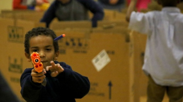 A Boys and Girls Club member shoots a nerf bullet at one of his friends during the nerf war on Nov. 30.
 Photo by Kayla Drake