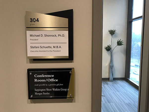 The sign in the Presidents office in the Library and Academic Resources Center that still displays President Michael Shonrocks name.  Photo by Tyler Keohane