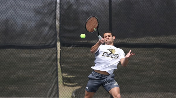 Freshman Juan Albin hits a volley during the doubles match against Missouri Valley on Saturday afternoon.  Photo by Merlina San Nicolás. 