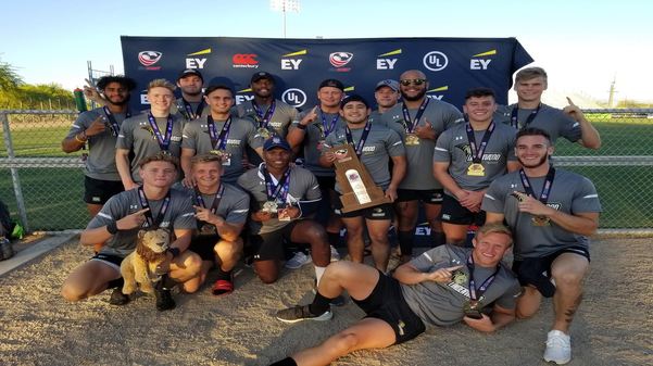 The Lindenwood mens rugby team poses with the trophy after winning.  Photo by Nic Tyson. 