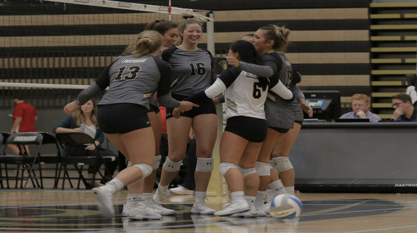 In the center, Kelly Willson (16) celebrates with her teammates after winning a point against Flagler College on Friday night at Hyland Arena. 