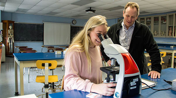 Associate Professor C. Greg Anderson helps alumna Ally Clancy with her research project in 2018.  Photo from Ally Clancy