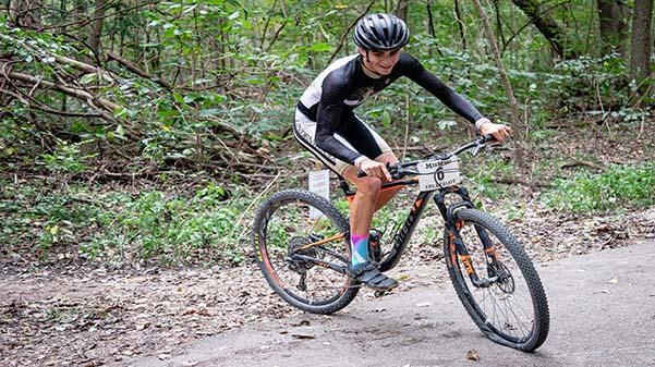 Lindenwoods Cayden Whitehill (6) finishes up his race with the flat tire at Mountain Bike Conference Championships.  photo by James Tananan