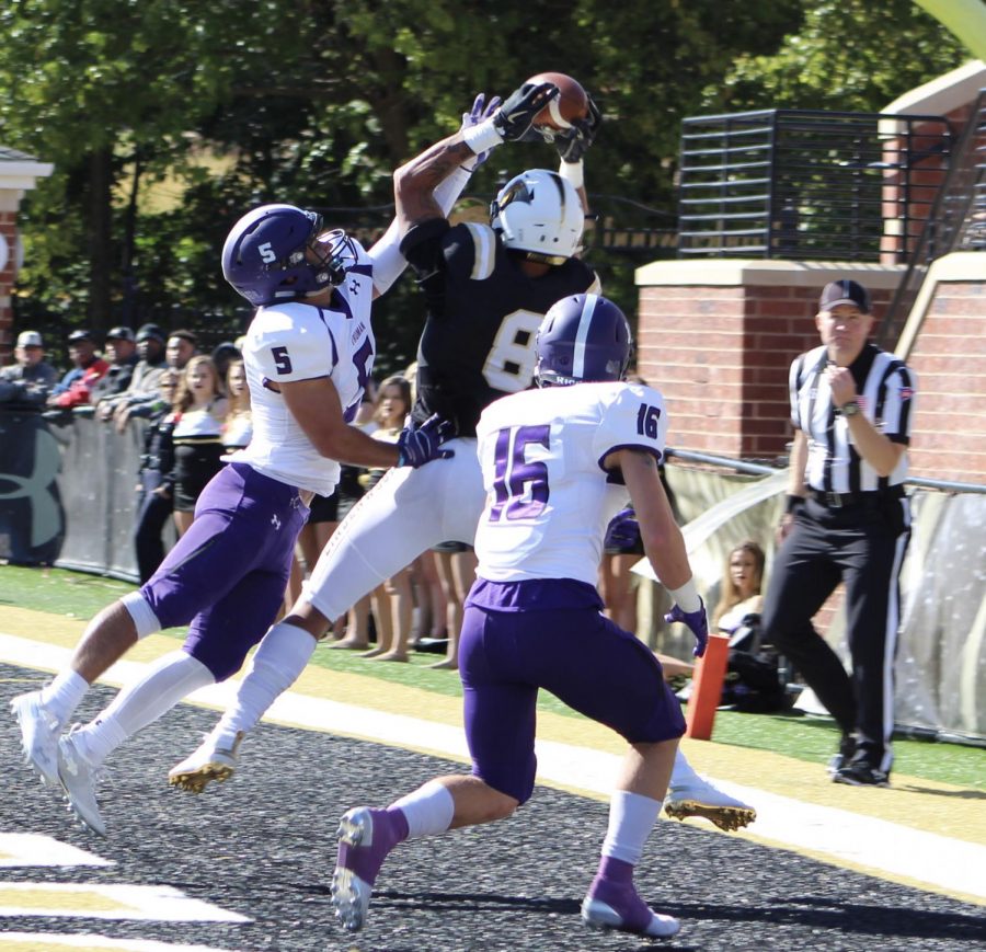 No. 5 Zach Nadle and no. 16 Ben Watson try to steal the ball from senior Erik Henneman who successfully completed the touchdown against Truman State during Homecoming Day at Harlen C. Hunter Stadium.