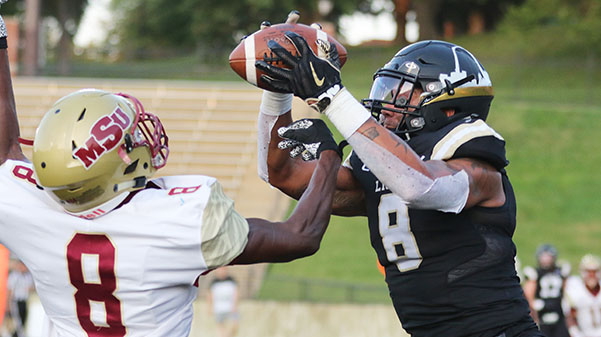 Erik Henneman, (right) catches a pass during a game against the Midwestern State University Texas on Sep. 14 at Harlen C. Hunter Stadium.