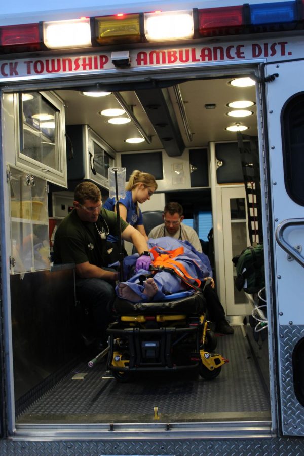 Lindenwood paramedic students assess their patient in ambulance while transporting them to the emergency room.