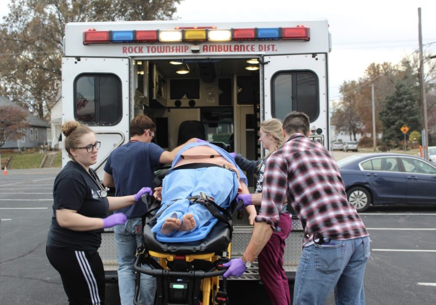 Lindenwood paramedic students lift a fake car accident victim into an ambulance in under 10 minutes during their Trauma Lanes simulation. 