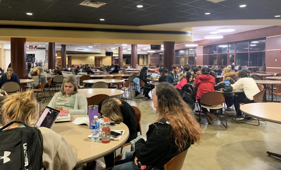 Students hang out in Spellmann Dining Hall, waiting for permission to return to their dorms on Dec. 10.