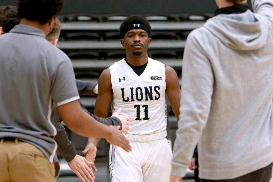 Kevin Caldwell Jr. (#11) gets greeted by members of the mens basketball team during Lindenwoods home victory against Southwest Baptist on Jan. 30.  