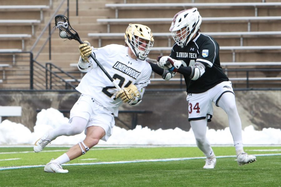 Carter Collins (left) takes on a Florida Tech defender during Lindenwood's 13-12 win in the 2020 season opener on Feb. 8, 2020.