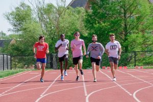 Ben Stasney (left), Edward Kipruto, Timothy Maxwell (middle), Brady Mello, and Louis Moreau (right) run in a group on April 30 during a practice on the Lindenwood track. 