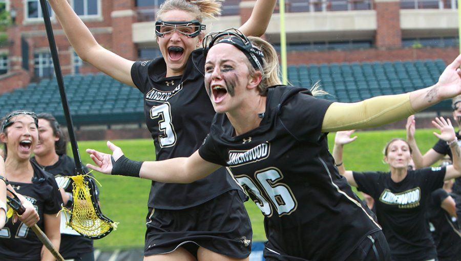 Erin McGuire (36) celebrates with teammates as womens lacrosse defeats No. 1 Indianapolis on May 16 at Hunter Stadium.