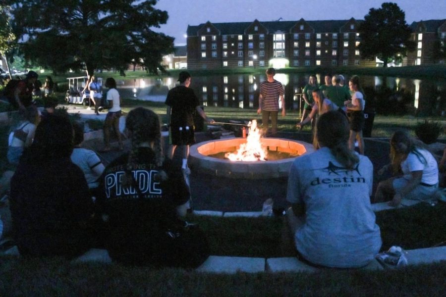 Students sit next to the new fire pit during New Student Orientation week for the 2021-22 school year. 