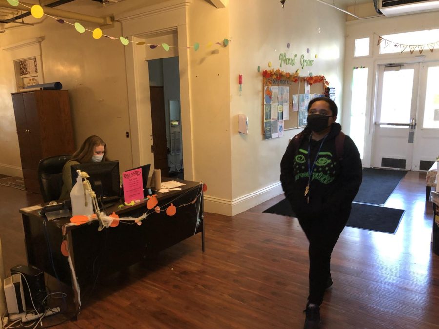 Student Agnes Adams (right) and Community Advisor Evie Sue Ward (left) wearing their masks in the hallway of Sibley Hall.