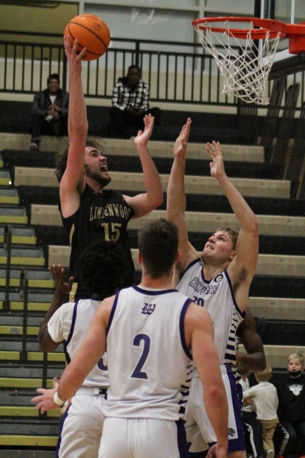 Freshman foward Frazier Ott attempts to hit a layup over two defenders in Lindenwoods home game against Kentucky Wesleyan on Saturday, Nov. 13.