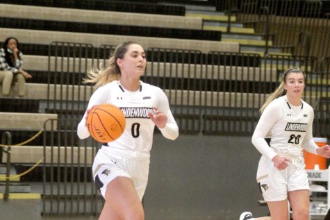 Sophomore guard Gracie Neff brings the ball up court during a matchup against Quincy University.