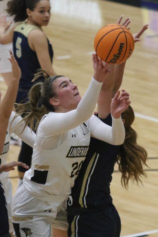Senior Forward Ellen McCorkle attempts to make a layup over defenders from University of Illinois Springfield. McCorkle finished the game with a season-best of 25 points. 