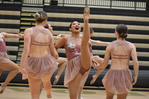 Junior Bella Castro (center) demonstrating her flexibility in the Lionettes jazz routine. The Lionette’s Jazz routine took first place at the 2022 National Championship.