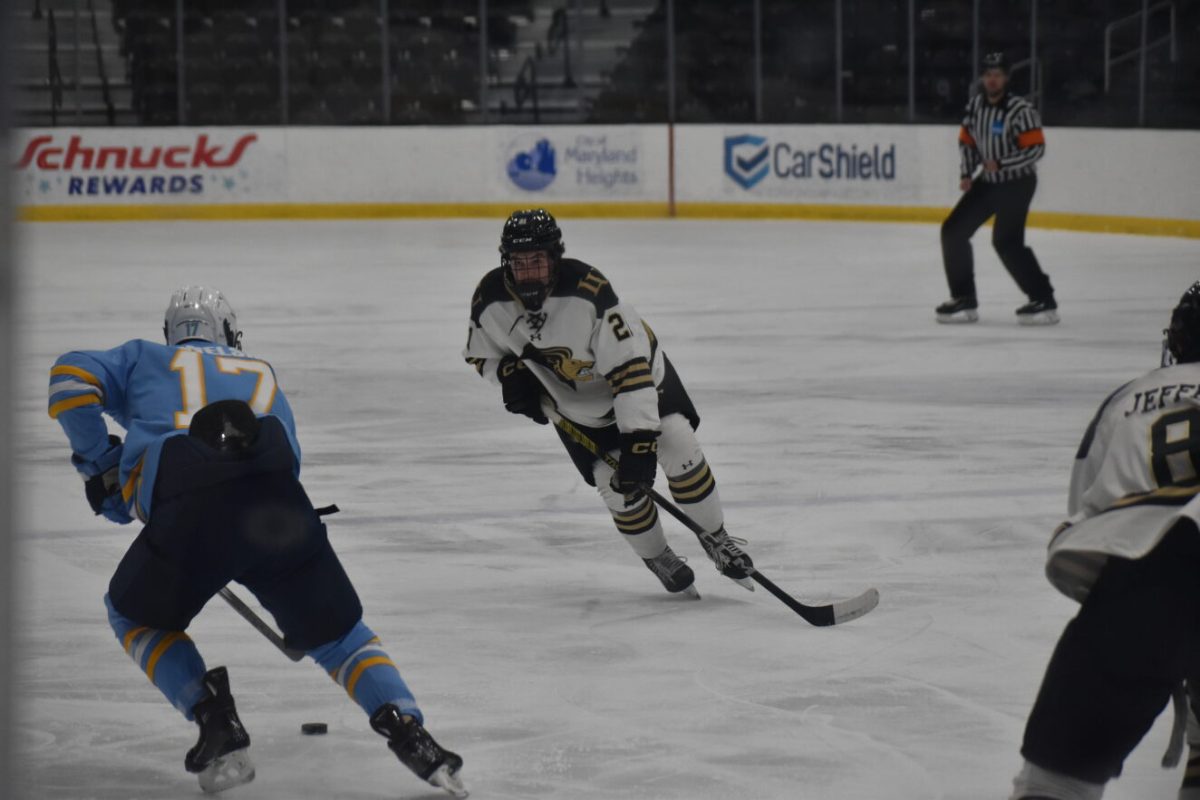 Forward Jake Southgate passes the puck towards a teammate in a game against Long Island University. 
