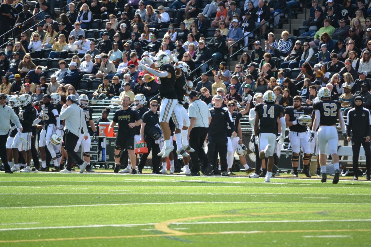 Two Lindenwood players celebrate after a play. 