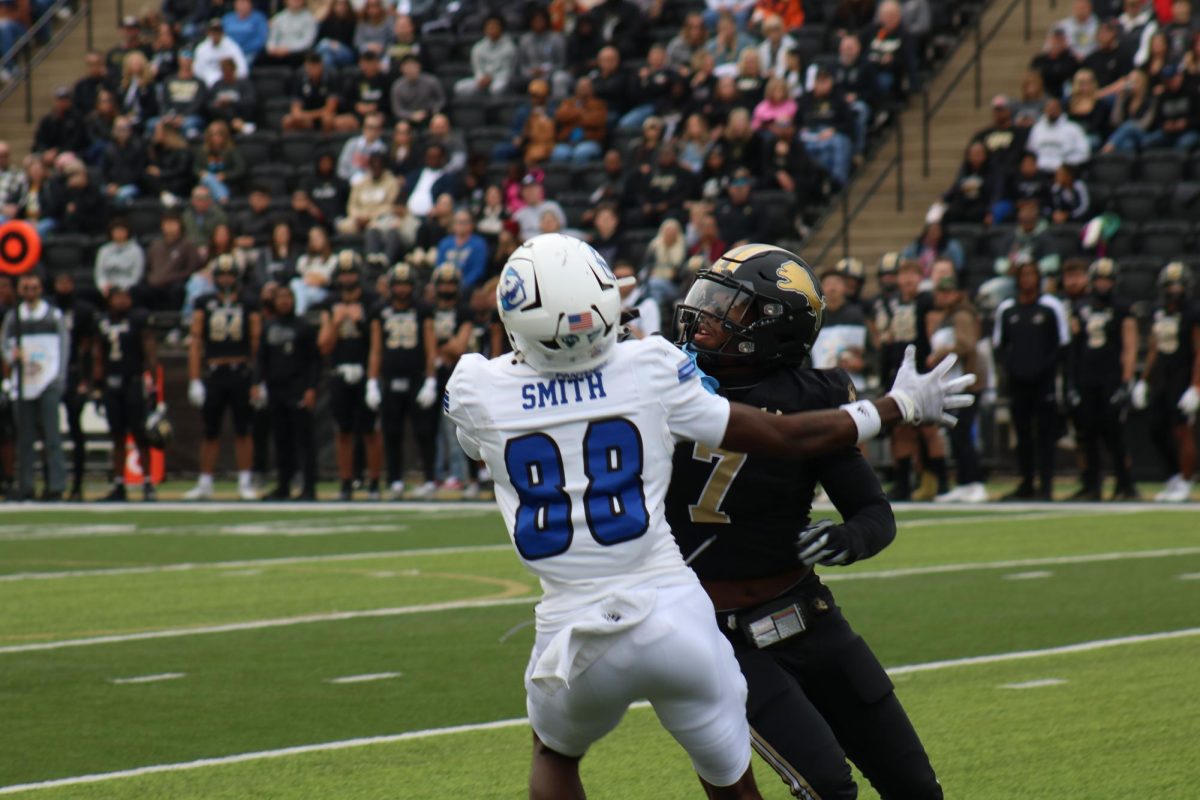 Jayden Patrick prepares to jump with a Panthers receiver for a ball thrown downfield from the EIU quarterback. 