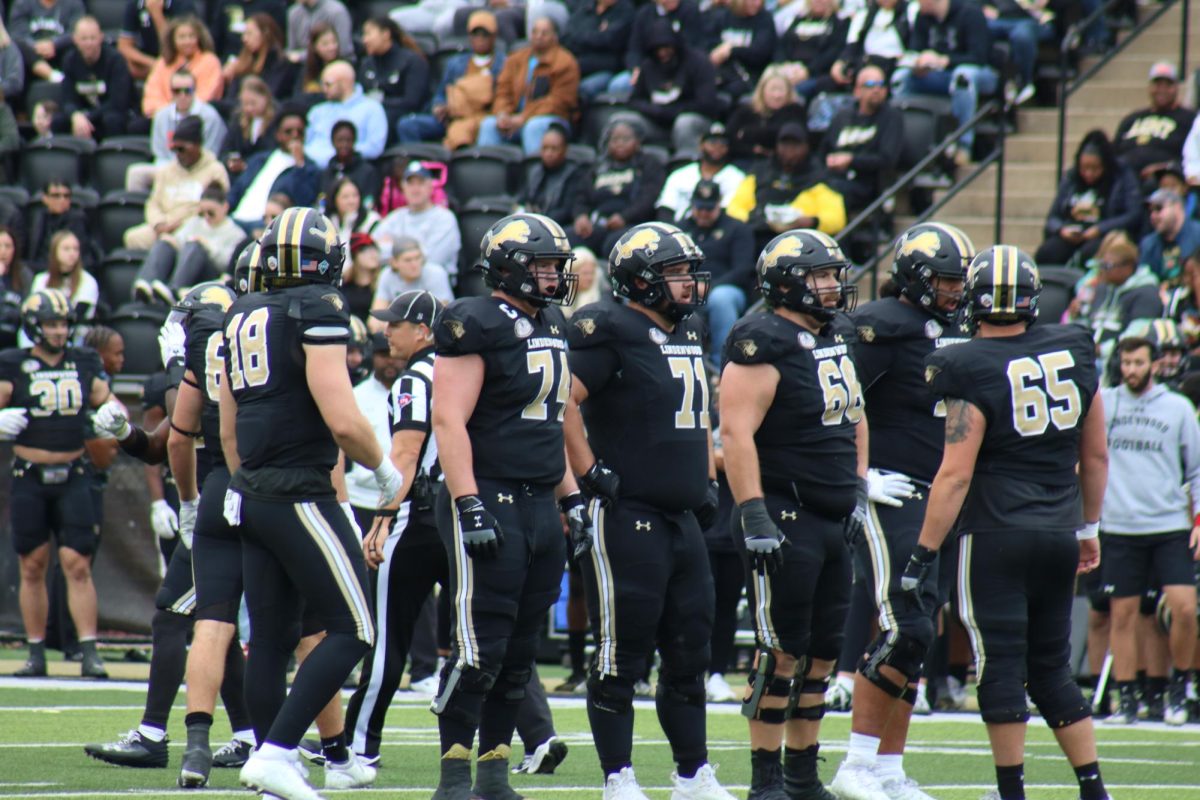 Members of the Lindenwood Lions offensive line watch downfield, as they prepare for an upcoming play at the line of scrimmage. 