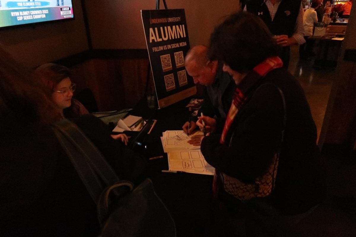 Members of the KCLC alumni sign in to the alumni reunion at Shamrock Bar & Grill