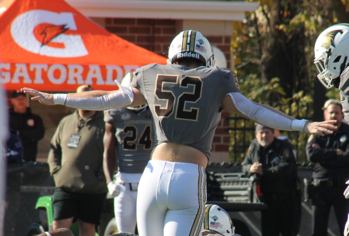 Linebacker Brendan Dye signals his arms during a play against Bryant University. 